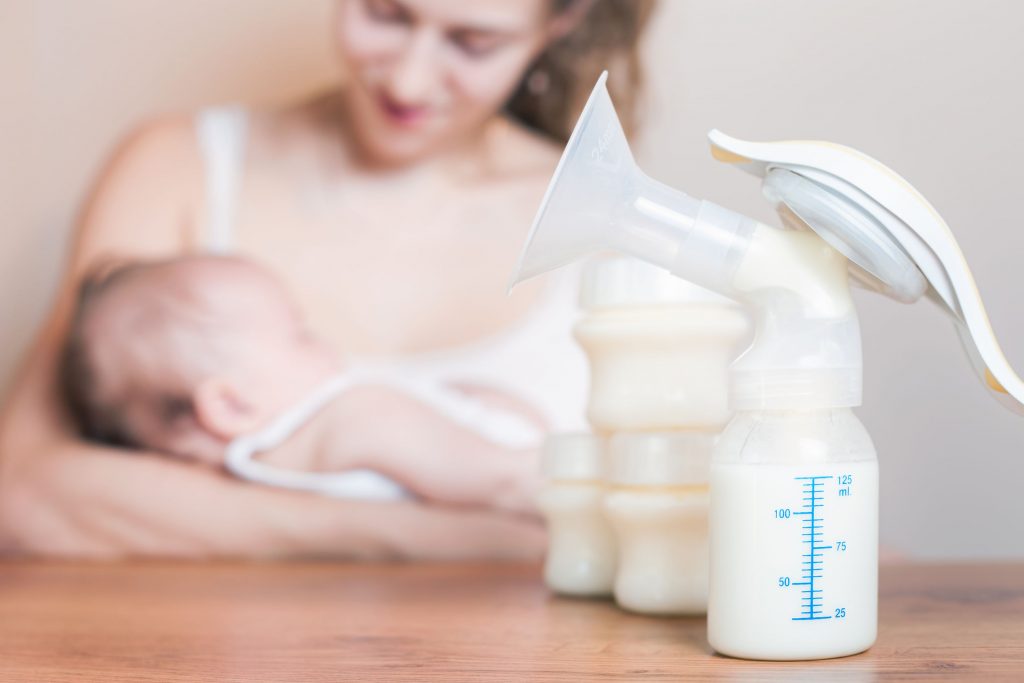 mom, baby, and breast pump