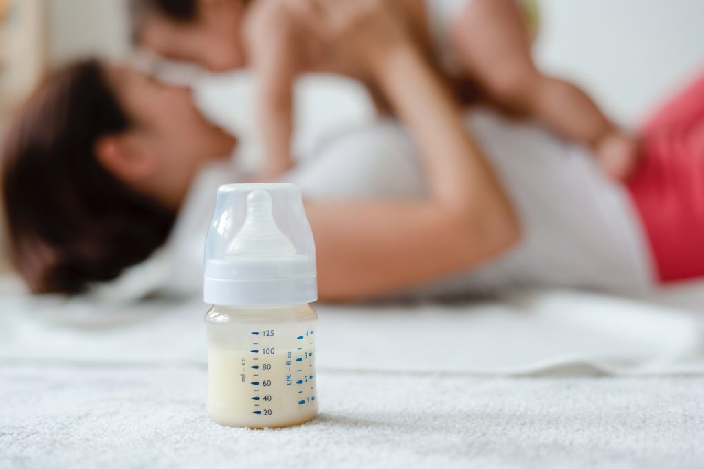 mother feeding baby formula